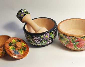 Wooden decorative dishes. Wooden dishes. Wooden tableware with painting. Floral pattern. Mortar and spices. Plate. Salt container