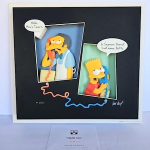May include: Framed artwork depicting two cartoon characters on the phone, with speech bubbles. One says "Hello. Moe's Tavern." The other says "Is Seymour there? Last name. Butts." The artwork has a black background and a white frame. The title is "CRANK CALL".