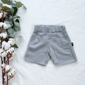 May include: Grey cotton shorts with a small black label on the side.