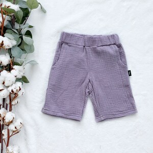 May include: Purple cotton shorts with a small black tag on the side.