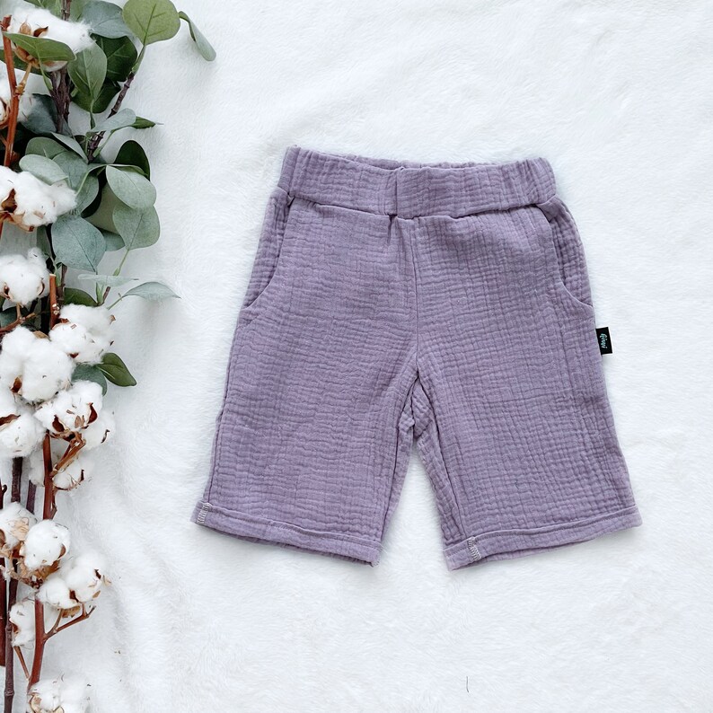 May include: Purple cotton shorts with a small black tag on the side.