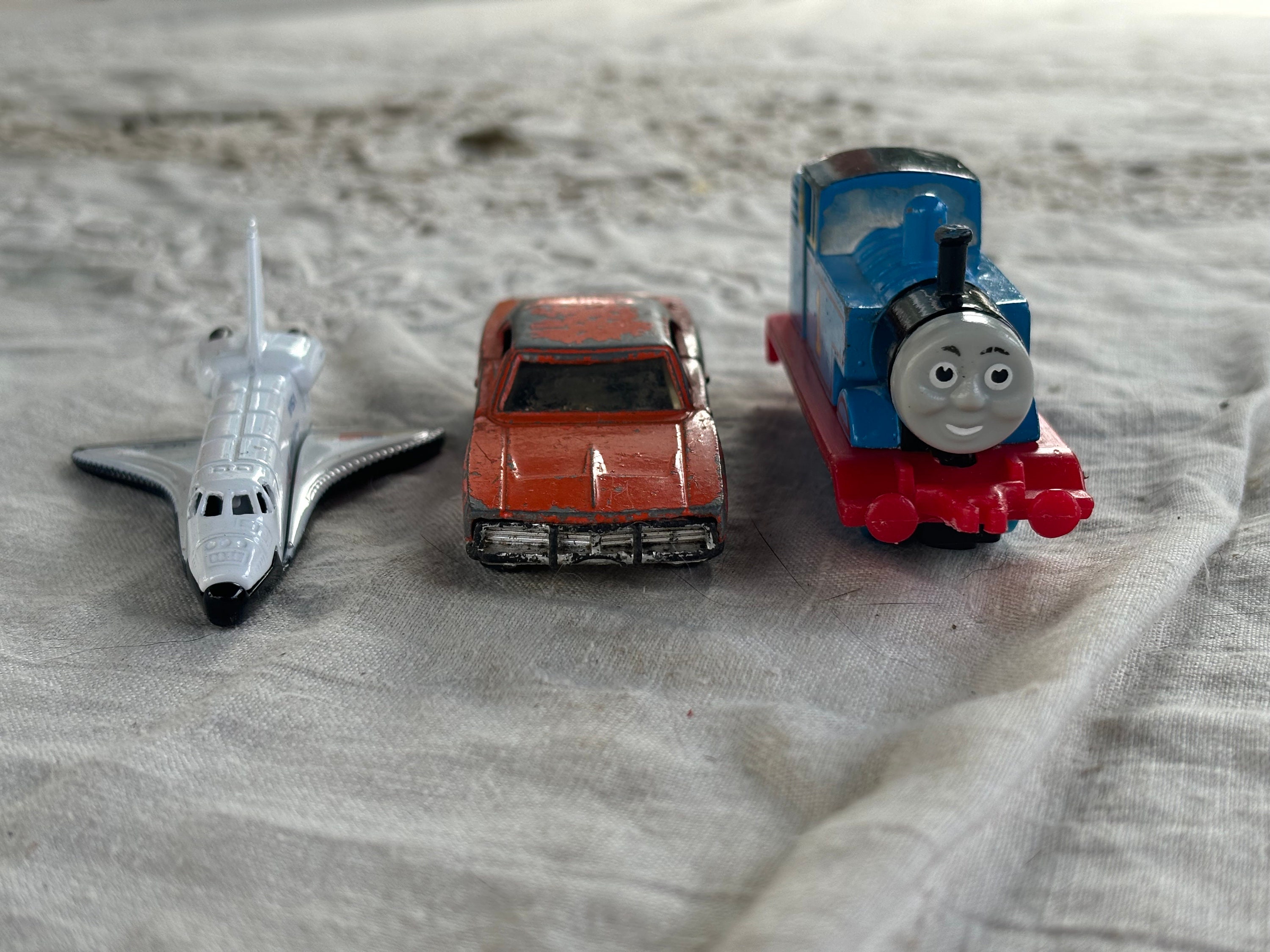 Three Pieces of Ertl Die Cast Toys. 1985 Thomas The Train. 1990 NASA Space Shuttle. 1981 Dukes of Hazzard Car.