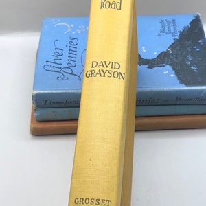 May include: A yellow hardcover book titled "The Friendly Road" by David Grayson. The book is published by Grosset & Dunlap.