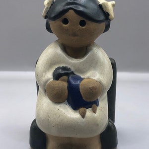 Studio Pottery Little Girl Figurine Holding Her Doll While Sitting in a Chair.