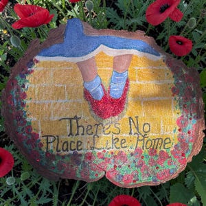 May include: A white ceramic mug with a black handle and the text "But First, Coffee" in a black, handwritten-style font. The mug is on a white surface.