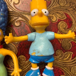 A Collection of The Simpsons Figurines.  Marge. Bart. Lisa.