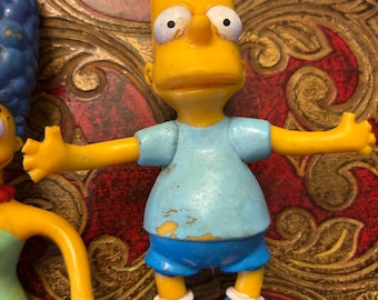 A Collection of The Simpsons Figurines.  Marge. Bart. Lisa.