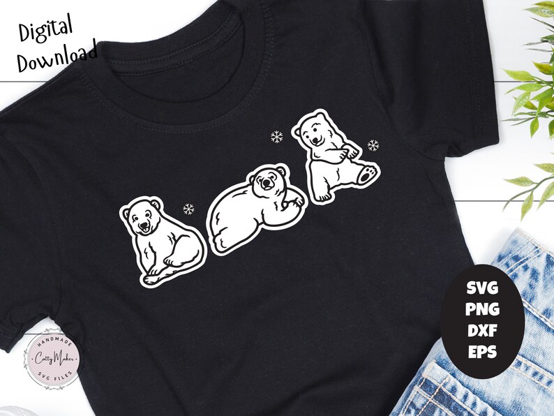 May include: A black t-shirt with a white outline of three polar bears. The bears are in different poses, one is sitting, one is lying down, and one is standing. The t-shirt has the text "Handmade Crafty Maker SVG Files" in the bottom left corner.