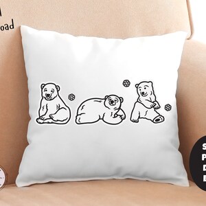 May include: A white pillow with three black and white polar bear illustrations. The bears are facing forward and have a snowflake design behind them.