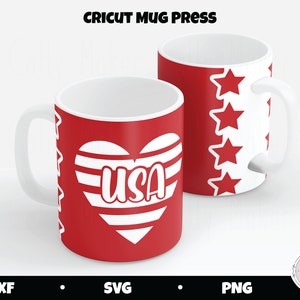 May include: Two red mugs with white handles. One mug features a white heart with red and white stripes and the word "USA" inside. The other mug has a white background with red stars.