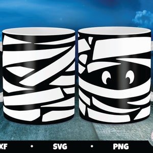 May include: Two white coffee mugs with black mummy designs. One mug has a full mummy design, while the other has a mummy face with eyes.