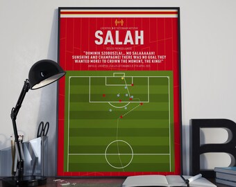 May include: A framed poster with a red background, featuring the name "SALAH" in white. The poster includes text about a soccer match and a diagram of the field. The text includes "DOMINIK SZOBOSZLAI... MO SALAAAAAH!" and the date 27th April 2025.