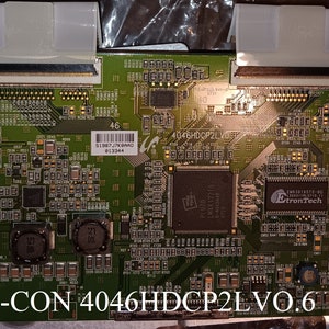 May include: A green circuit board with the text "T-CON 4046HDCP2LV0.6" printed on it. The board has several components, including a chip with the text "EtronTech" printed on it.