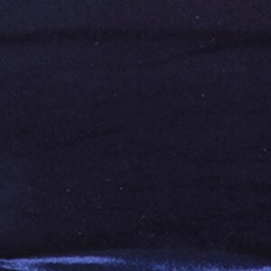 May include: A close-up of a dark blue velvet fabric. The fabric has a soft, plush texture and a subtle sheen.