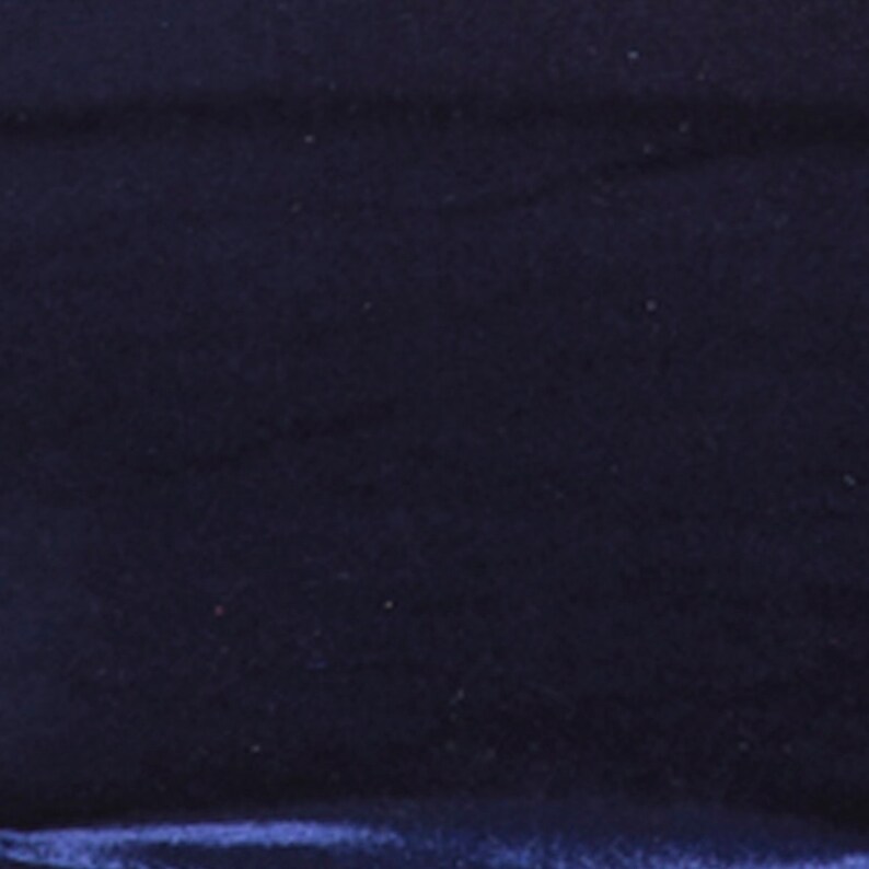 May include: A close-up of a dark blue velvet fabric. The fabric has a soft, plush texture and a subtle sheen.