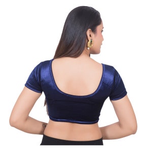 May include: A navy blue velvet blouse with short sleeves and a scoop neckline.