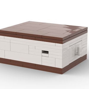 May include: A small white Lego building with a brown roof and a small door. The building has a small window on the side.