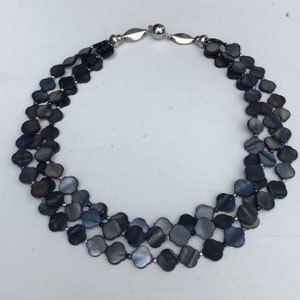 Subtle beauty. Three-row necklace made of ornamentally shaped blue-gray mother-of-pearl elements