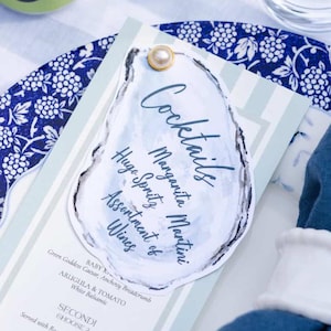 May include: A set of three ceramic mugs with a speckled, matte finish. The mugs are in shades of cream, light gray, and dark gray. Each mug has a simple, minimalist design, perfect for coffee or tea.