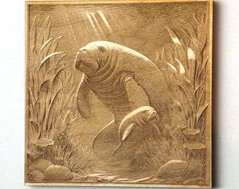 Manatee and her baby engraved Wall Decor. Swimming around with water plants that they eat near them. Great Wall decor!