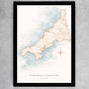 May include: A framed print depicting the Cornwall coastline in England. The map features a beige landmass with a blue watercolour sea. A compass rose is in the lower right corner. The text "Cornwall Coastline England" is at the bottom.