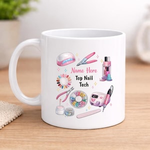 May include: White ceramic mug with a design of nail technician tools and the text "Name Here Top Nail Tech". The design includes a nail lamp, clippers, a drill, and nail art supplies in pink, purple, and white.