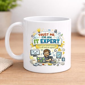 May include: White ceramic mug with a humorous IT-themed design. The mug features the text "TRUST ME, I'M AN IT EXPERT" with additional text, and a cartoon illustration of a person with a computer and other IT-related icons.