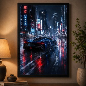 May include: A framed wall art print depicting a dark blue sports car driving down a rain-slicked city street at night. The scene features glowing red taillights, neon signs with Japanese text, and towering skyscrapers reflecting on the wet road.