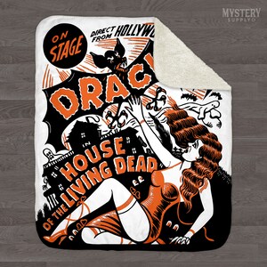 May include: A white fleece blanket with an orange and black illustration of a woman with long red hair, a bat, and a house. The text "On Stage", "Direct From Hollywood", and "Oracula in House of the Living Dead" is printed on the blanket.