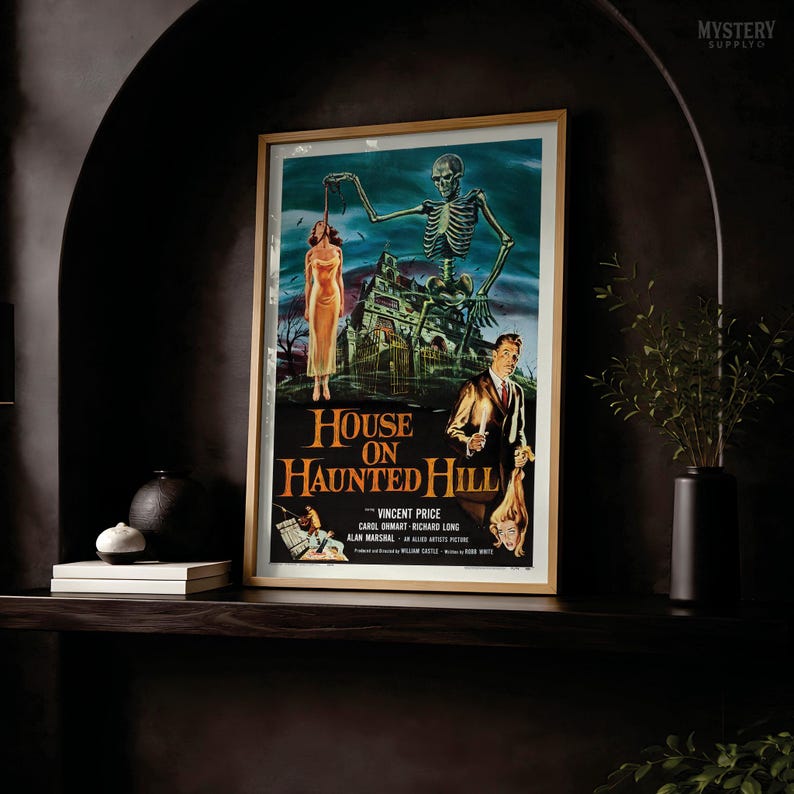 May include: A framed movie poster for House on Haunted Hill featuring a skeleton looming over a house, a woman in a yellow dress, and a man in a suit. The text reads House on Haunted Hill, Vincent Price, Carol Ohmart, Richard Long, Alan Marshal.