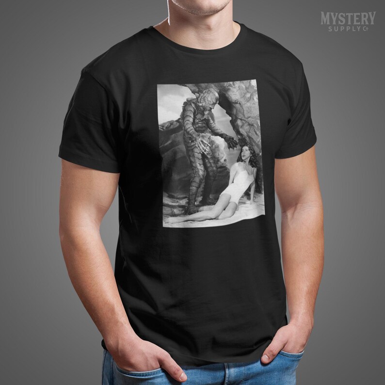 Creature from the Black Lagoon 1954 vintage horror monster Julie Adams swim suit and the gill man black and white photo Mens Womens Unisex T-Shirt from Mystery Supply Co. @mysterysupplyco
