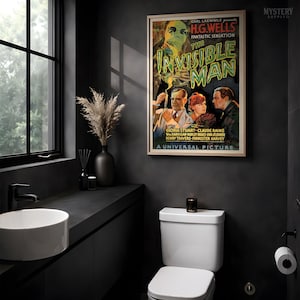 May include: A framed movie poster for The Invisible Man featuring a green-tinted ghostly figure above three people. The text reads Carl Laemmle presents H.G. Wells Fantastic Sensation The Invisible Man with Gloria Stuart, Claude Rains, and others.