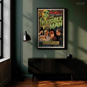 May include: A framed vintage movie poster for The Invisible Man, featuring a central illustration of a man with a bandaged face and goggles, surrounded by three actors, with bold green text and black background details in a rectangular wall display.
