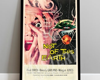 May include: A vintage movie poster for the science fiction horror film "Not of This Earth". The poster features a woman with a terrified expression on her face, covering her mouth with her hand. A large, green, alien creature with a single eye is seen in the background, with a red planet in the distance.