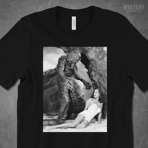 Creature from the Black Lagoon 1954 vintage horror monster Julie Adams swim suit and the gill man black and white photo Mens Womens Unisex T-Shirt from Mystery Supply Co. @mysterysupplyco