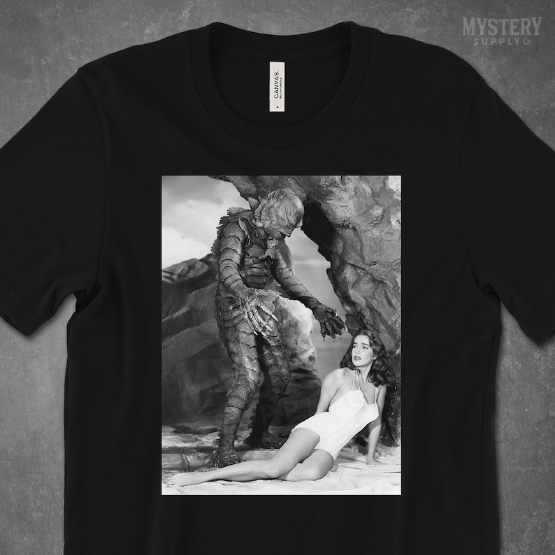 Creature from the Black Lagoon 1954 vintage horror monster Julie Adams swim suit and the gill man black and white photo Mens Womens Unisex T-Shirt from Mystery Supply Co. @mysterysupplyco