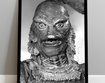 May include: A black and white framed print featuring a close-up portrait of the Creature from the Black Lagoon with textured scales, prominent gills, and wide eyes. The text MYSTERY SUPPLY is visible in the top right corner and across the center.