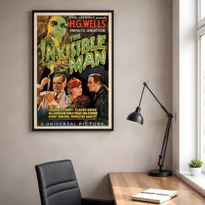May include: A framed movie poster for The Invisible Man featuring a ghostly figure in goggles above three people. The text reads Carl Laemmle presents H.G. Wells' Fantastic Sensation The Invisible Man with Gloria Stuart, Claude Rains, and others.