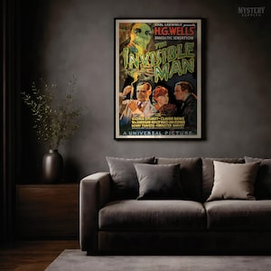 May include: A framed movie poster for the 1933 film The Invisible Man. The poster features a large, ghostly, translucent head at the top, with three people below in suits and dresses. The text reads Carl Laemmle presents H.G. Wells Fantastic Sensation The Invisible Man with Gloria Stuart, Claude Rains, William Harrigan, Dudley Digges, Una O'Connor, Henry Travers, Forrester Harvey, A Universal Picture.