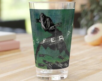 May include: A green glass pint glass with a black and white illustration of a creature with the text "NOSFERATU" printed on the glass.