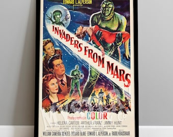 May include: A vintage movie poster for the film "Invaders From Mars" featuring a green Martian holding a woman in a red dress. The poster is in color and has the text "Photographed in Color" and the names of the actors and production company.