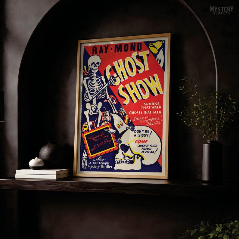 May include: A rectangular framed poster titled Ghost Show featuring a skeleton, a skull, and various spooky illustrations in red, blue, and yellow. The text includes Ray-Mond, Spooks That Walk, Ghosts That Talk, and Don't Be A Sissy, Come Even If Your Heart Is Weak.