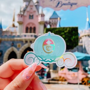 May include: A handmade wooden sign with the text "Welcome" in a playful font. The sign features a distressed white background and a dark stained wooden frame. A small, decorative heart is attached to the sign.