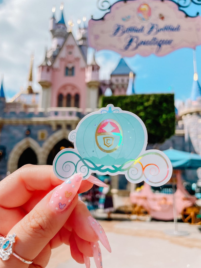 May include: A handmade wooden sign with the text "Welcome" in a playful font. The sign features a distressed white background and a dark stained wooden frame. A small, decorative heart is attached to the sign.