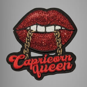 May include: Embroidered patch featuring red glitter lips with gold chain detail and white teeth. The patch has the words "Capricorn Queen" in red script on a black background.