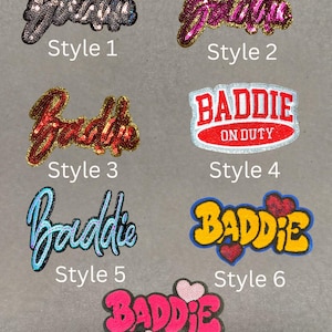 May include: Collection of seven sequined patches with the word "Baddie" in various styles. Styles include silver, pink, red, and blue sequins, and a patch with the text "BADDIE ON DUTY". Some designs feature hearts.