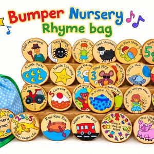 May include: A light blue drawstring bag with white polka dots and a collection of round wooden discs featuring colourful hand-painted illustrations and text representing various nursery rhymes, arranged on a tiered wooden display stand.