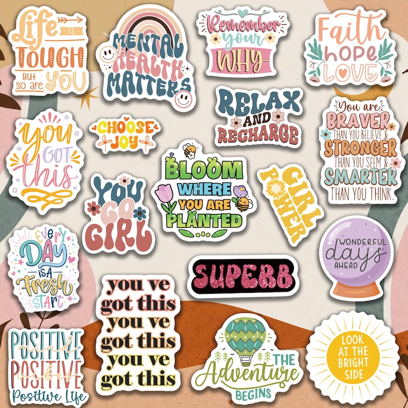 May include: A collection of colorful stickers with inspirational quotes and phrases. Designs include rainbows, flowers, and motivational words like "Bloom Where You Are Planted" and "You Got This." The stickers are in various shapes and sizes.