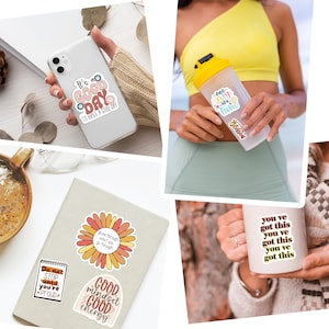 May include: Collection of stickers with motivational quotes and designs. Includes stickers with phrases like "It's a good day to have a good day," "One day at a time," and "You've got this." Also features a floral design and a notebook sticker.