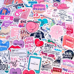 May include: A collection of colorful stickers featuring various designs related to books and reading. Some of the stickers include phrases like "The Book Was", "Smut", "Only One", "In Love With a Fictional Man", and "Light It Up".